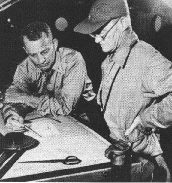 Two of Task Force 58's dream-team staff: Vice-Admiral Mitscher discussing plans with his Air Officer, Jimmy 
Thatch